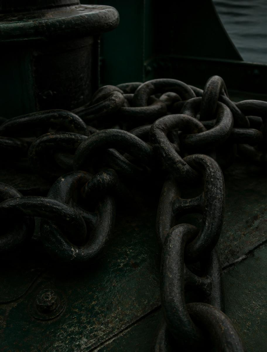 Heavy steel anchor chain coiled on a ship deck